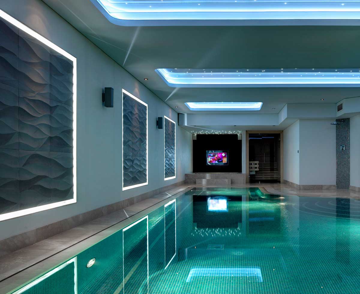 Indoor pool featuring modern ceiling lighting design