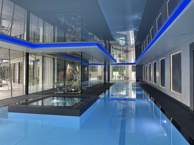 Contemporary pool ceiling with colour-changing LED lighting