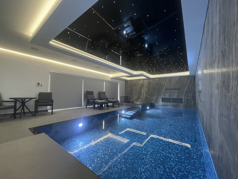 Stretch ceiling above indoor pool with ambient twinkle lighting