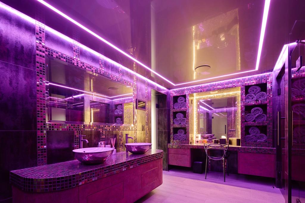 Backlit stretch ceiling in luxury indoor pool changing area
